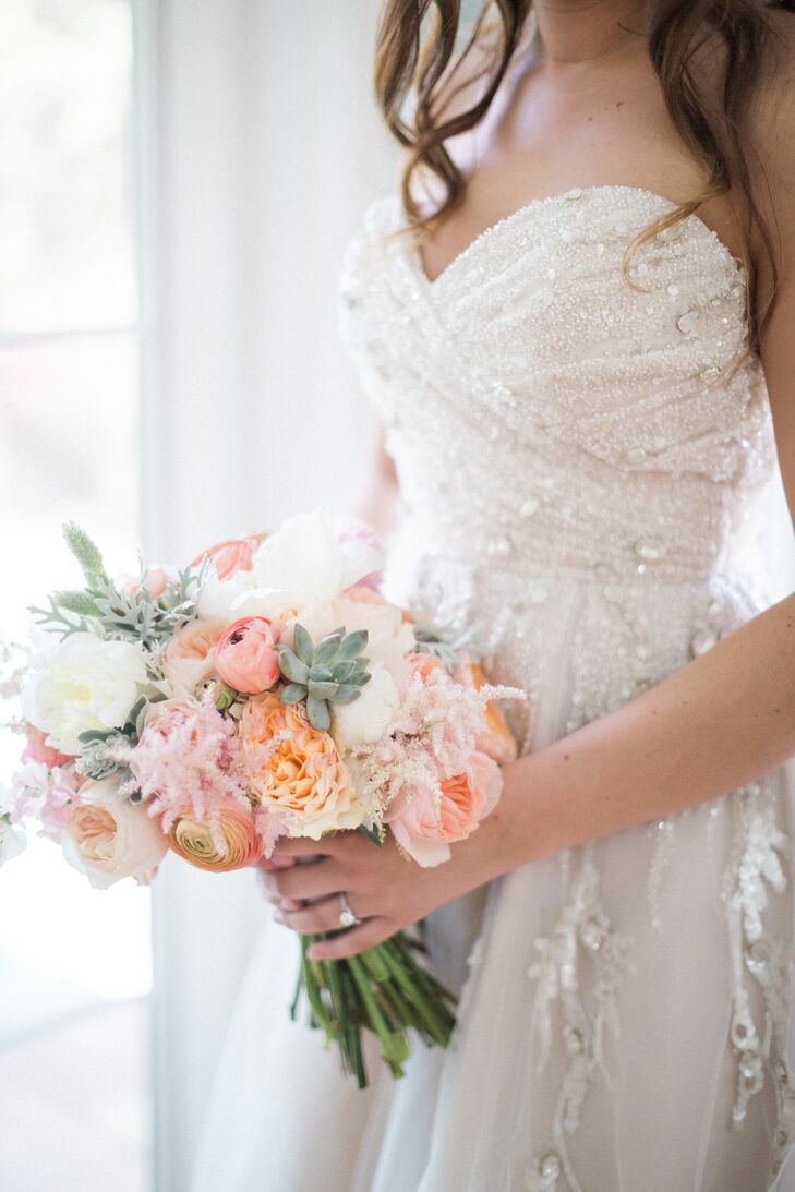 Using photos as inspiration, Stephanie worked with the pros at Isn’t She Lovely Florals and came out with a bouquet that was exactly what she envisioned. The blush ribbon-tied arrangement was filled with peach and white peonies, coral and pink ranunculus, blush garden roses, pink and white astilbes, succulents and dusty miller. Now that's one unexpected combination!