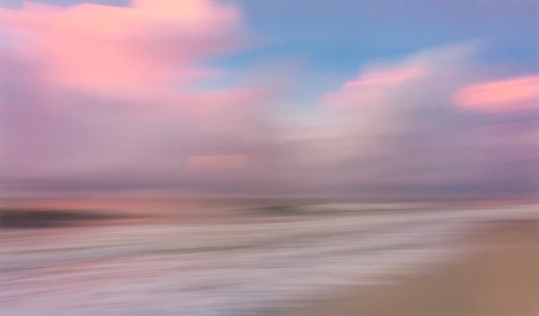 myrtle beach sunrise pink clouds and sand and blue skies and artistic interpretation of the atlantic ocean