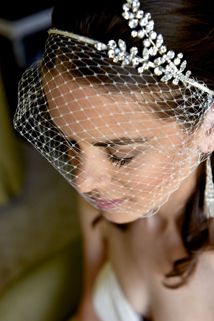 Julie wore a netted birdcage veil with a vintage twist, which was accented with a crystal design on top. The look of the veil went nicely with her wedding dress, which was strapless and accented with a thin crystal belt.