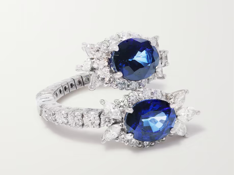 A silver ring with two oval-shaped sapphires.