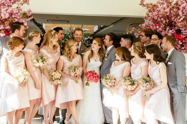 For their wedding party, Kate and Jordan went for a classic aesthetic with a subtle midcentury edge. Jordan’s groomsmen donned traditional Jack Silver suits in dark gray, while the bridesmaids wore tea-length Lela Rose dresses with V-shaped bateau necklines and asymmetric hems.