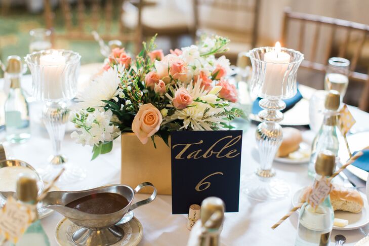 Given that Pitt’s colors are navy and gold, it was no surprise that the same hues popped up at Brenna and Eric's reception at Pittsburgh Athletic Association in Pittsburgh, Pennsylvania. Each table was marked with gold vase centerpieces and a DIY navy table number that had handwritten gold script. “We designed the short centerpieces to bring in the feel of our romantic garden ceremony,” Brianna says.