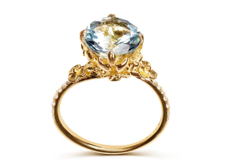 Aquamarine center stone with floral inspired setting on thin gold band with pave diamonds