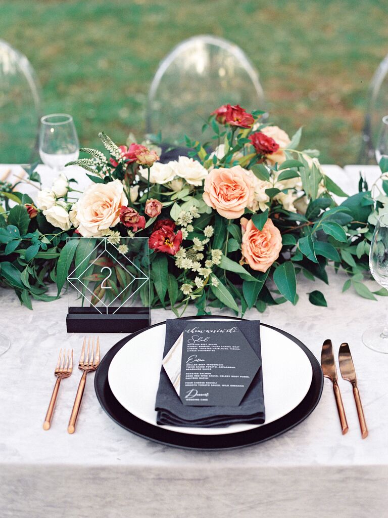 low fall wedding centerpiece with pink roses, greenery and acrylic square table numbers