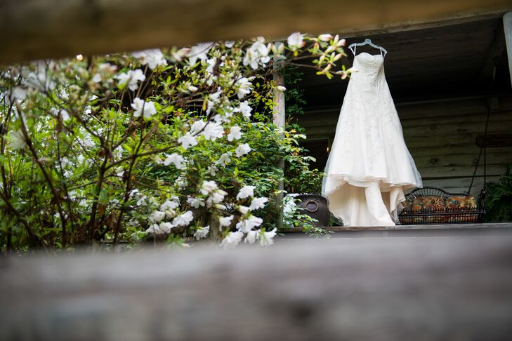 Ashley wanted to keep the wedding day's fashions simple and classic. She wore a David's Bridal strapless, A-line wedding dress with a sweeping train and lace detailing paired with a waist-length veil she borrowed from her sister.