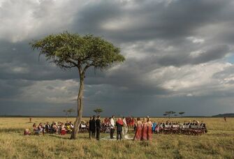 Traditional ceremony taking place underneath an acacia tree. 