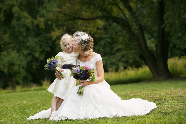 The flower girl wore a dress that used to belong to Kate. She accessorized with a deep purple sash.