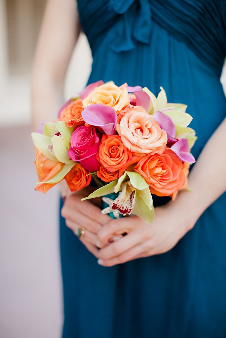 Roses, orchids and calla lilies in shades of orange, pink and green filled the bridesmaid bouquets.