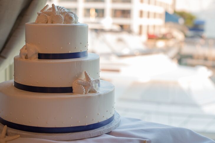 Katie and Steve had Cakes for Occasions whip up a summery, nautical-inspired confection for their post-dinner treat. The three-tier vanilla cake was filled with fresh strawberries and vanilla buttercream frosting, and had white chocolate seashells, playful polka dots and pieces of bright blue ribbon decorating its layers.