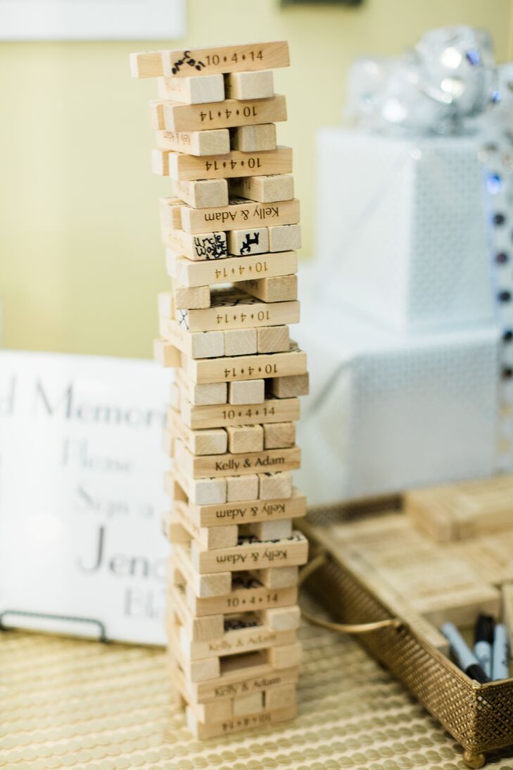 A fun alternative to the traditional guest book, the couple asked their guests to sign Jenga blocks that were laser cut with their wedding date.