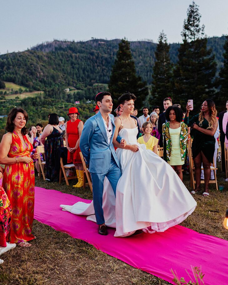 Bride and Groom Processing Into Ceremony on Pink Aisle Runner