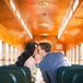 Chi and Ryan Kissing on Wood Trolley