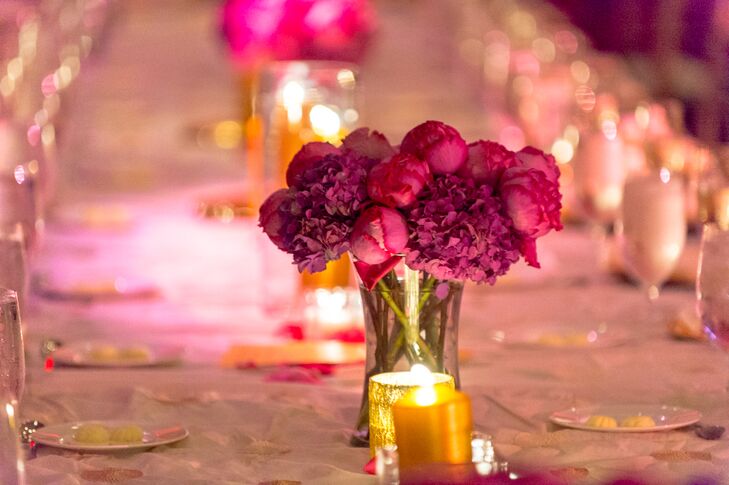Arrangements of fuchsia peonies sat among the gold pillar candles. The bright florals spoke for themselves, without any additional flowers in the arrangements.