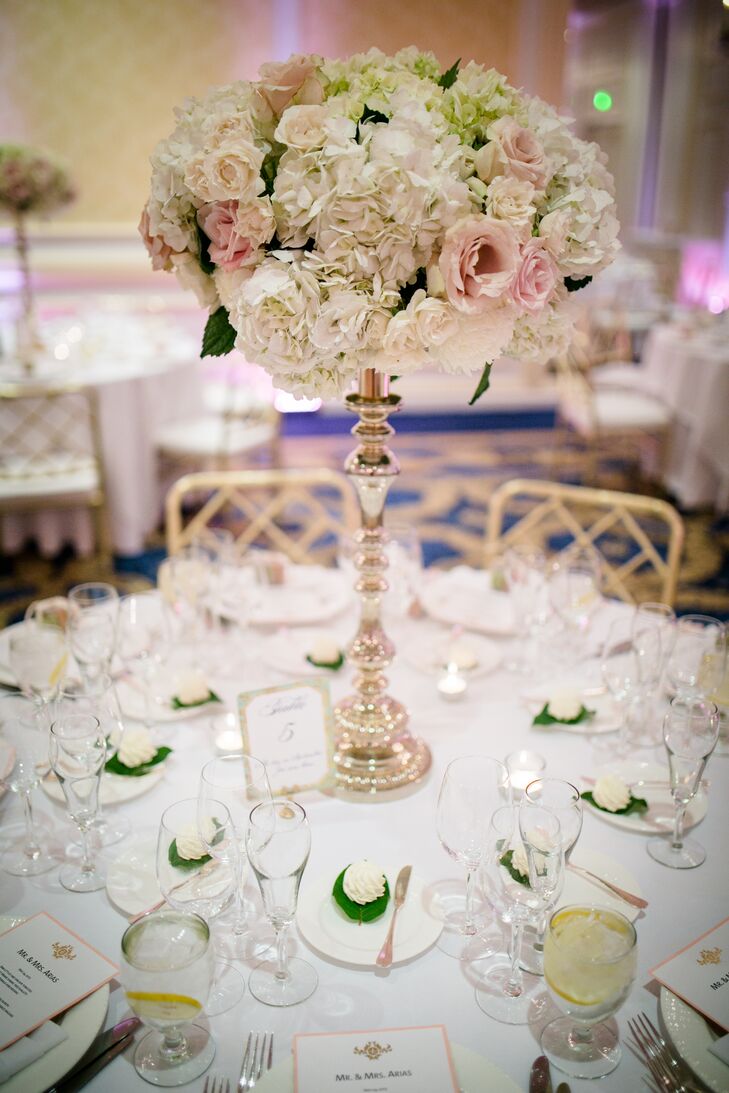 To bring Rebecca and Jonathan’s opulent, spring theme to life, Mimosa Floral Design created arrangements of lush seasonal blooms displayed on elegant silver candelabra pedestals. Ivory hydrangeas, chrysanthemums and blush roses and spray roses infused the room with a soft, romantic feel, while tying into the evening’s classic, timeless vibe.