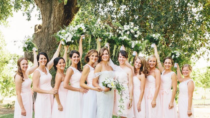 Anna stood with her bridesmaids, who wore differently styled blush dresses at the wedding.