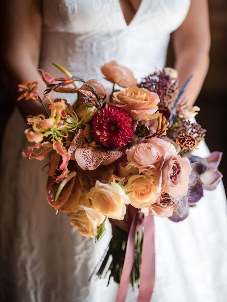 Bride holding bouquet with lilies