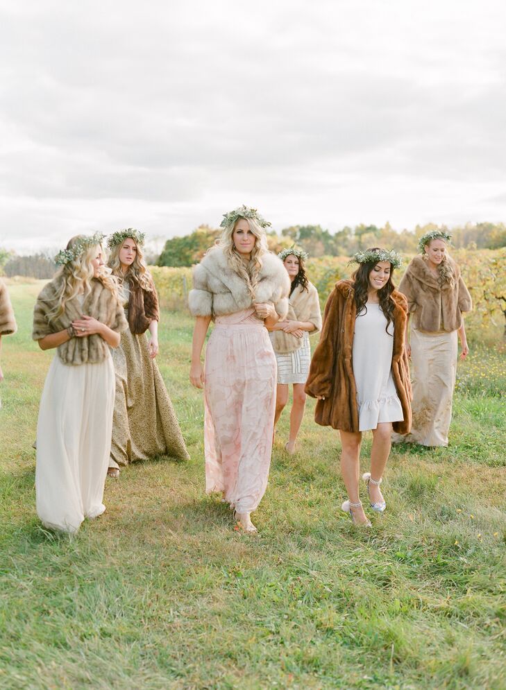 Each of Lauren's bridesmaids wore mismatched dresses in various shades of ivory and blush. Fur wraps were added for a luxe detail that was perfectly whimsical.