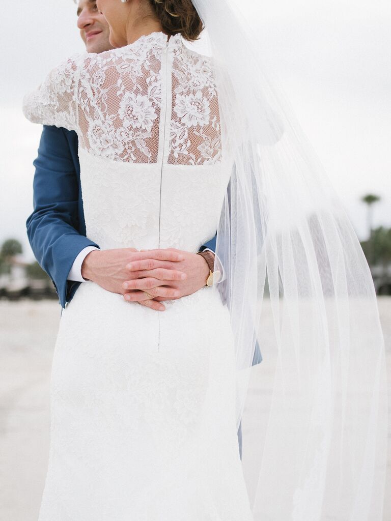Long-sleeved lace wedding dress with chapel-length veil