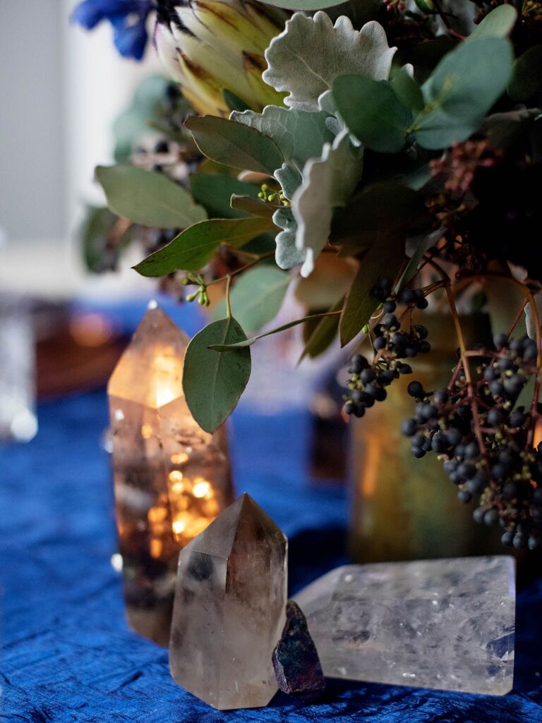 Scattered crystal centerpieces on celestial wedding reception tablescape