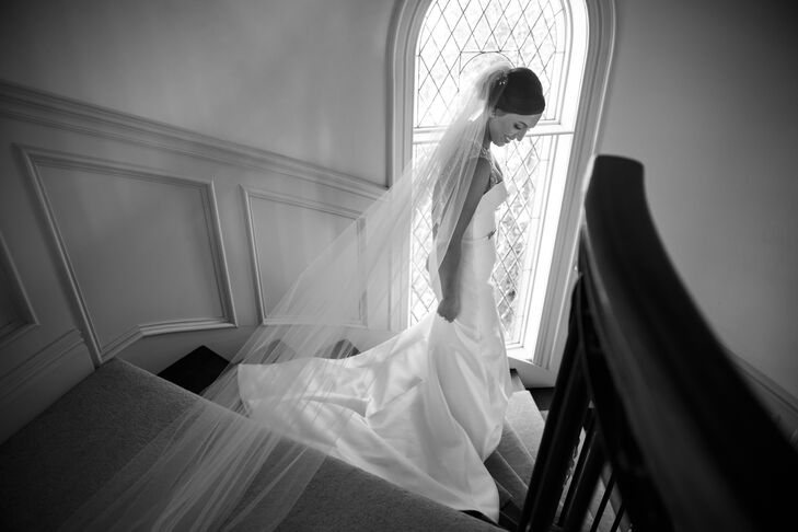 As Jackie walked down the staircase, her elegant cathedral-length veil simply made of tulle trailed behind her. She purchased the veil at Martina's Bridal—the same bridal store where she bought her dress.