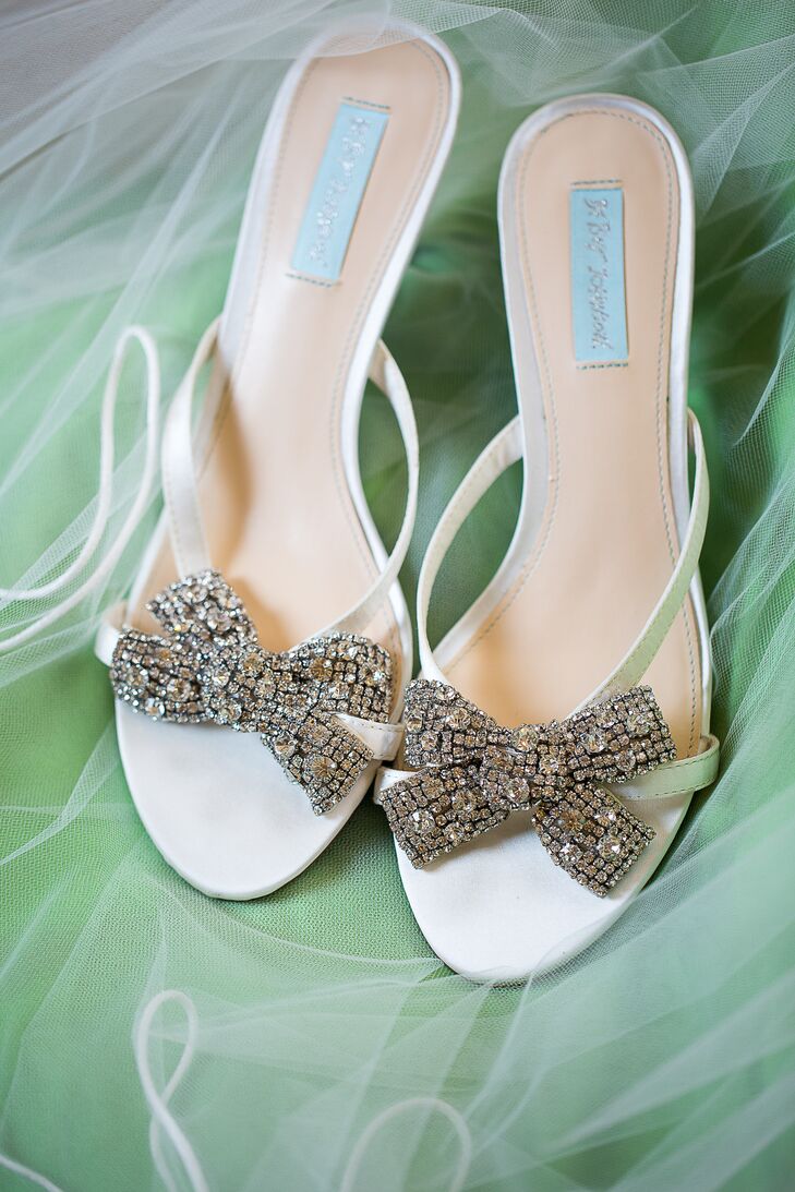 Caitlin wore pale blue sandal heels with rhinestone embellished bows at the toes by Betsy Johnson.