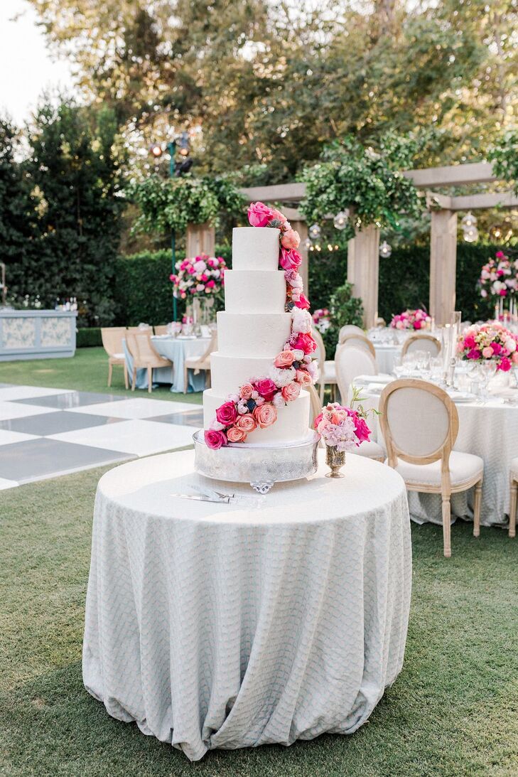 Five-Tier White Wedding Cake With Cascading Fresh Flowers in Jewel Tones, Pink, Fuchsia, Coral