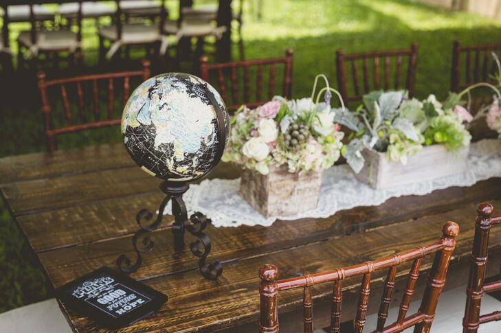 Roxy and Rodney's vintage style definitely came out in the reception decor. Guests took their seats among family-style wood tables topped with flowers, lace runners and a few unexpected details, including a chic black globe.