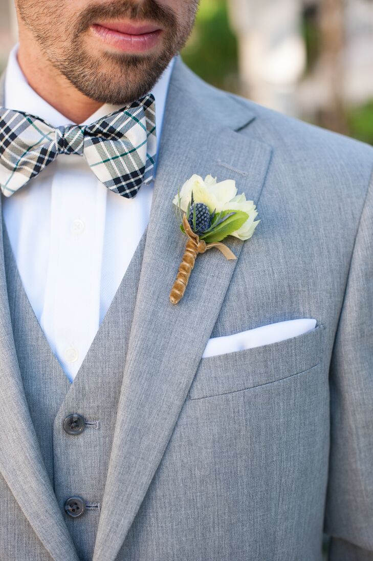 Craig had a single ivory rose boutonniere accented with greens pinned to his light gray suit jacket. He wore a light gray vest underneath the jacket, along with a gray and white plaid bow tie.