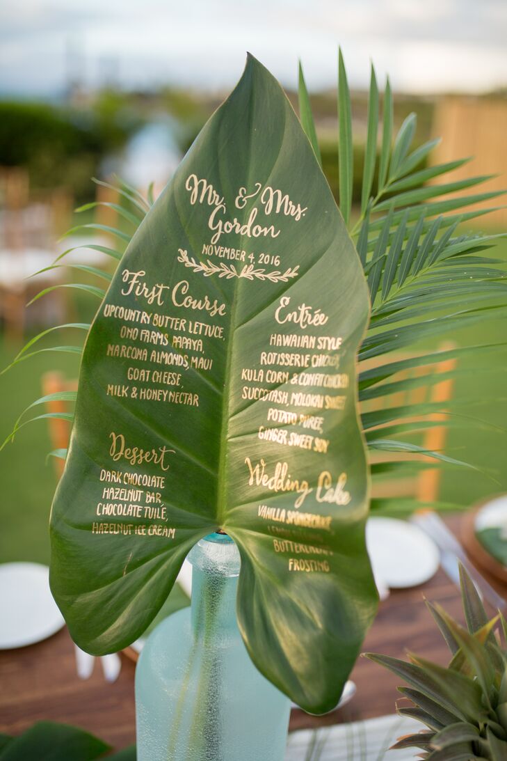 Each menu was calligraphed in gold on a large tropical leaf.