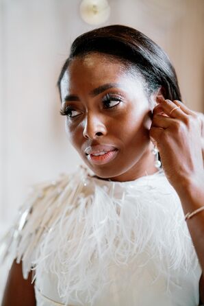 Bride in Beaded Wedding Dress Getting Reading and Putting on Earrings