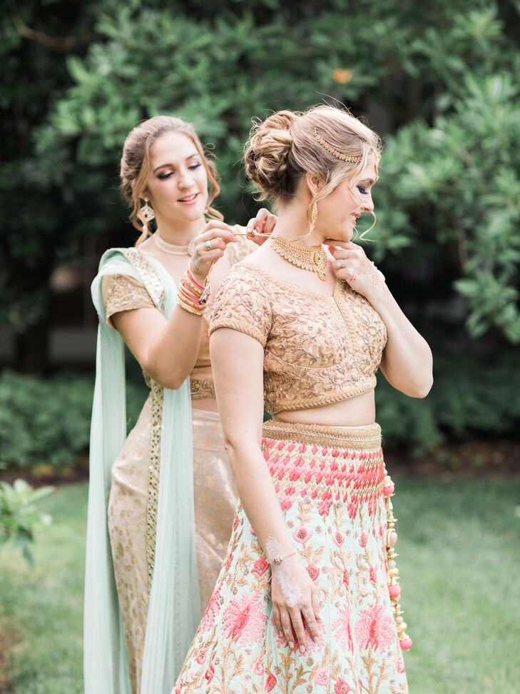 "My lehenga consisted of an embroidered gold top was a greenish blue with pink flower accents and a matching scarf," says Arselie, who changed into a purple velvet lehenga for the reception.
