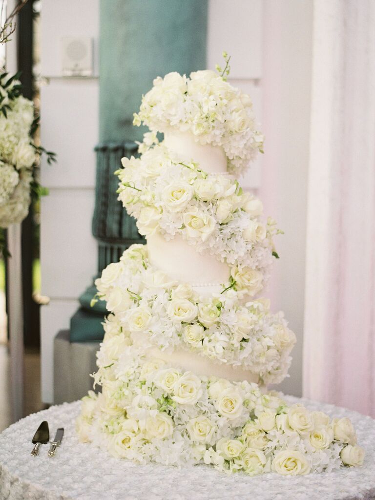 glamorous flower wedding cake wrapped with white roses spiraling down the cake
