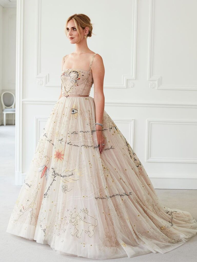 Chiara Ferragni wears a long dress with funky embellishments. 