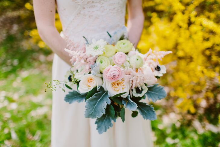 The bride held a bouquet with an assortment of garden rose, ranunculus, anemone, astilbe, dusty miller and eucalyptus flowers, designed by Green Meadows Florist.