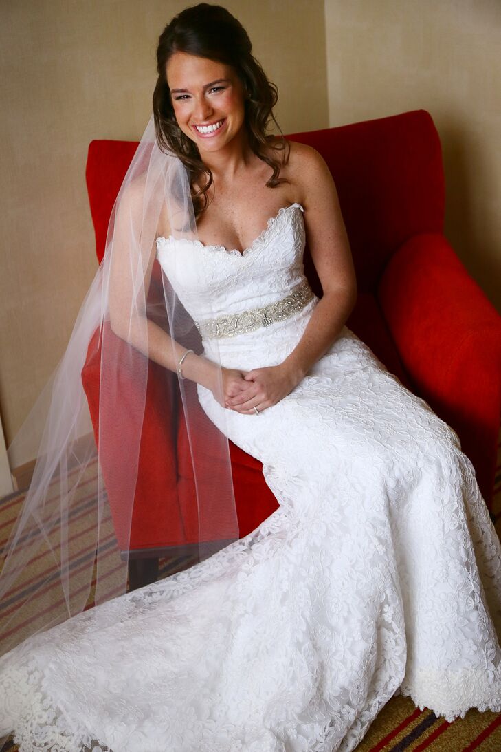 Kristen wore a Romona Keveza fit to flare gown with lace detail. She accessorized her bridal look with a jeweled belt and traditional veil.
