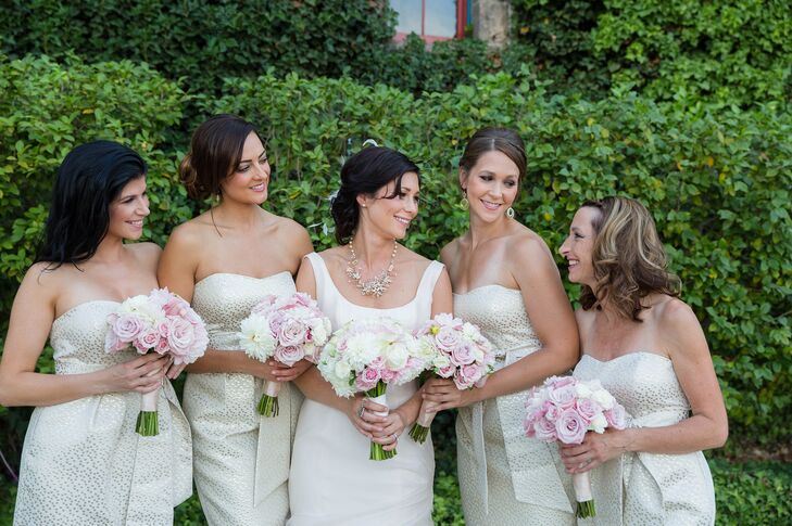 The bridesmaids wore gold strapless Jenny Yoo dresses with a subtle polka dot pattern.