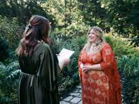 Brides exchanging wedding vows during wedding ceremony