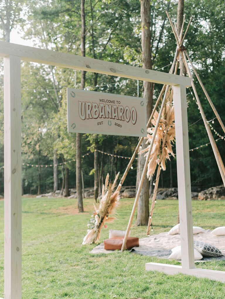 Wood teepee installation at outdoor boho wedding reception