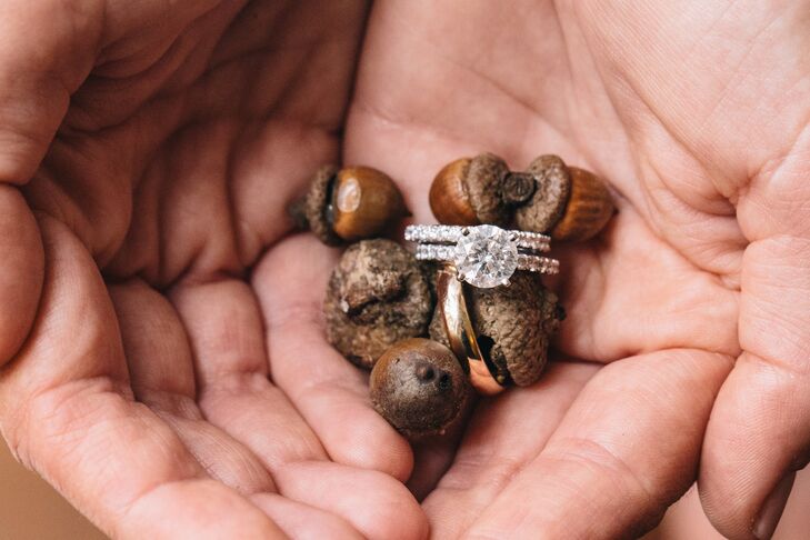 The bride wore a round-cut diamond engagement ring with a matching wedding band, and the groom wore a simple gold band.