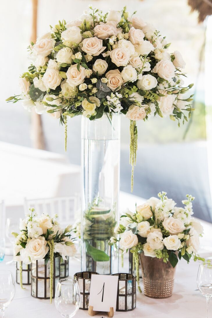 At the reception, which took place at the Rosewood Mayakoba in Riviera Maya, Quintana Roo, Mexico, Vanessa Jaimes Floral Design created high and low centerpieces with white blossoms and subtle greenery.