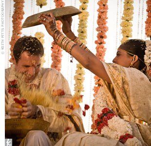 Harini playfully poured rice over Andrew as part of a ritual to determine who would wear the pants in the relationship -- whoever finishes first is the winner.
