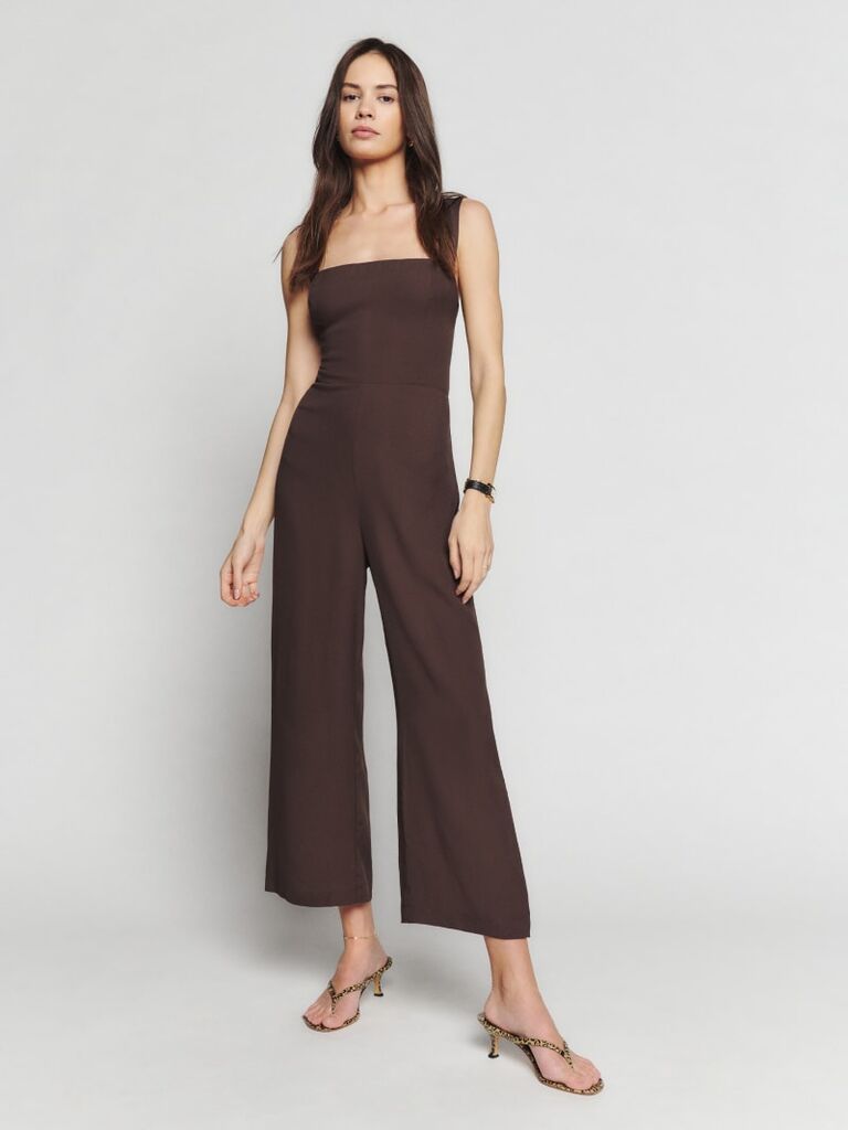 Model wearing brown jumpsuit with small straps and a relaxed pants