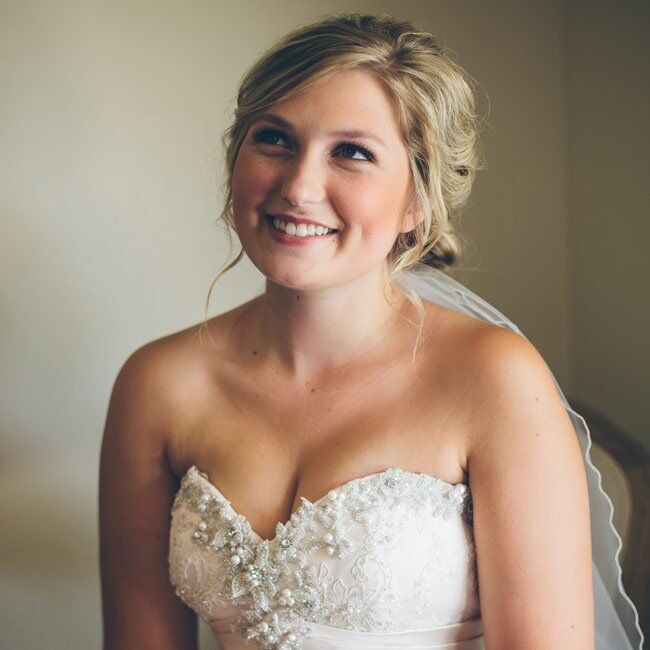 For her hair, Madison opted for romantic tousled waves and braids gathered into a low chignon paired with natural-looking makeup. A simple homemade veil added a traditional element to the look.