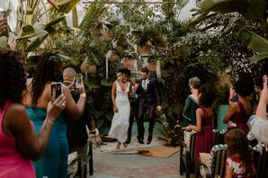 The Bride and Groom Jumping The Broom at a Tropical-Themed Wedding