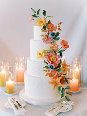 Four-Tier White Wedding Cake With Geometric Pattern, Cascading Bright Flowers