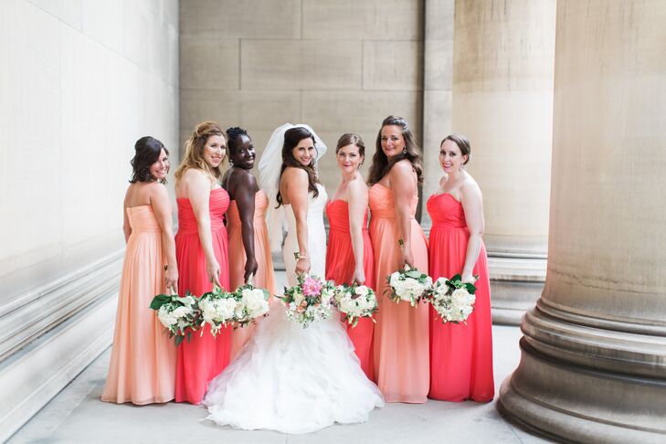 Brenna's bridesmaids rocked their peach and coral Donna Morgan looks for the spring wedding. The women wore strapless, long dresses with sweetheart necklines and ruching along the bodice. The chiffon skirts matched it with slight pleating that extended from the empire waist. Aside from the different colors, everyone showed their personalities with different hairstyles.