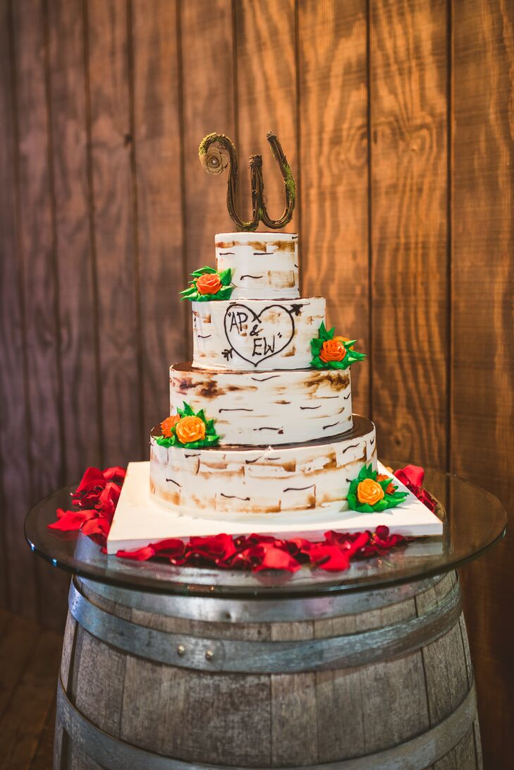 It doesn’t get more rustic than this! Ashley and Eric worked with Palermo’s Bakery to design a four-tier, round, strawberry and lemon wedding cake that resembled birch wood. Each buttercream-frosted layer mimicked their wooden accents and was even paired with bright orange sugar roses. A sweet wooden “W” also topped the confection. Those who dislike cake weren’t left behind. A plate of homemade doughnuts was set on each table.