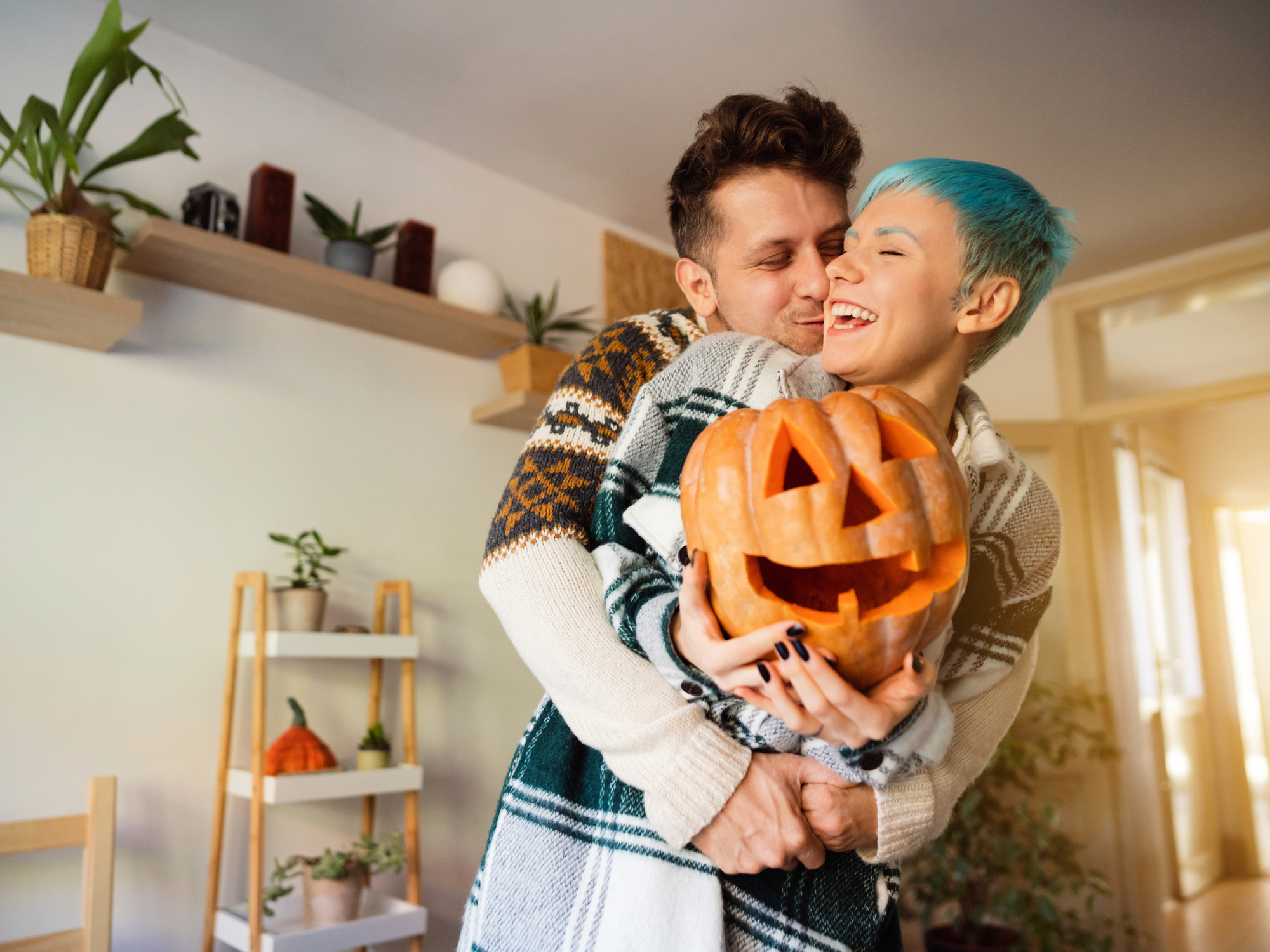 Cheerful couple with Jack O' Lantern pumpkins