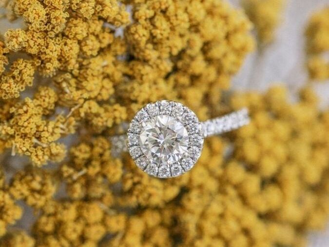 Engagement ring sitting on yarrow stem