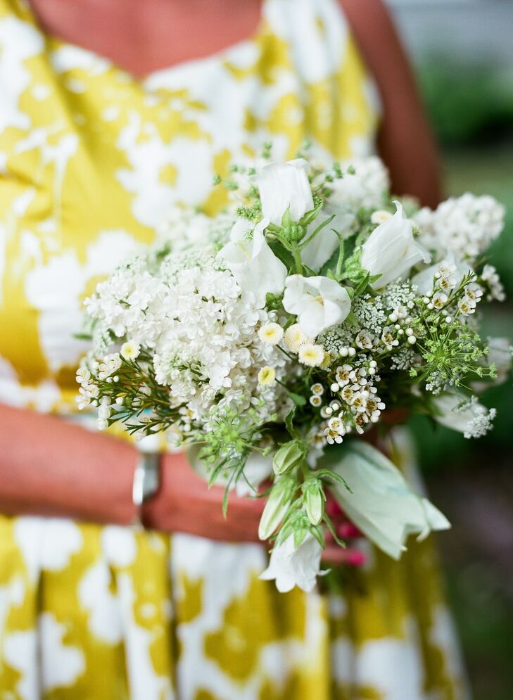 Fragrant white lilacs, button mums, wax flowers and other blooms were simple yet elegant additions to the bridesmaid bouquets.